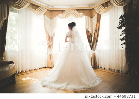 Portrait of beautiful bride with fashion veil at wedding morning Portrait of beautiful bride with fashion veil at wedding morning 44698731