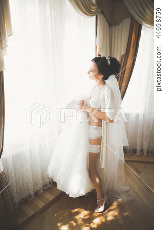 Portrait of beautiful bride with fashion veil at wedding morning 44698759