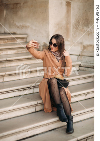 Beautiful girl in sunglasses make photo on smartphone. selfie Beautiful girl in sunglasses make photo on smartphone. selfie 44698763