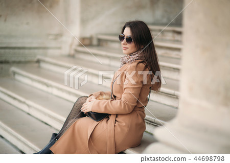 Attractive lady in autumn coat and sunglasses smile to camera 44698798