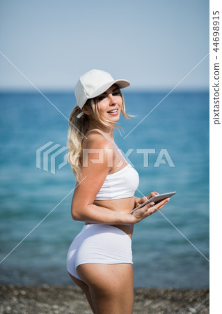 healthy gym blonde girl searches for new lifestyle fitness apps on her computer tablet 44698915