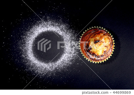 Assorted with Delicious homemade cupcakes with raisins and chocolate on black background. Muffins 44699869