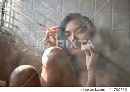 Smoking concept. Sexy women are smoking in the room. Sexy women 44700750