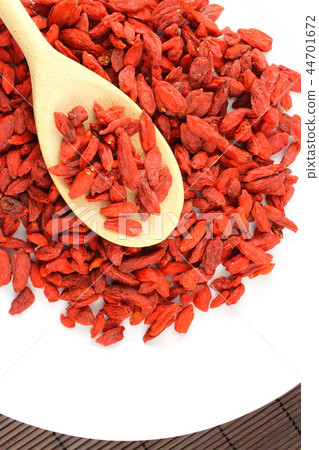 dried goji berries on a wooden spoon 44701672