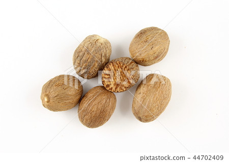 nutmeg seeds isolated on a white background nutmeg seeds isolated on a white background 44702409