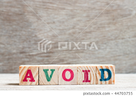 Letter block in word avoid on wood background 44703755