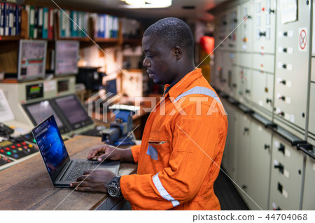 Marine engineer officer working in engine room 44704068