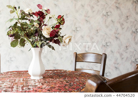 vintage living room with round dining table with flowers and pattern wallpaper vintage living room with round dining table with flowers and pattern wallpaper 44704520