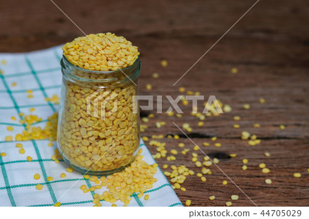 Peeled split soy bean on wood background. Peeled split soy bean on wood background. 44705029