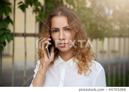 A focused young girl in a white blouse A focused young girl in a white blouse 44705066