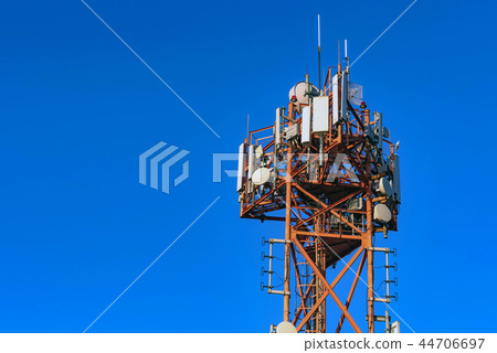 Top of cellular radio tower against blue sky Top of cellular radio tower against blue sky 44706697