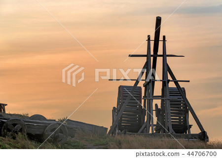 Old wooden catapult against sunset sky background Old wooden catapult against sunset sky background 44706700