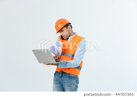 Engineer, architect, on busy face speaks on smartphone while holds blueprints. Man, foreman in 44707365