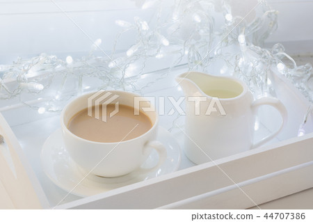 Cup of black coffee on winter windowsill. Xmas. 44707386