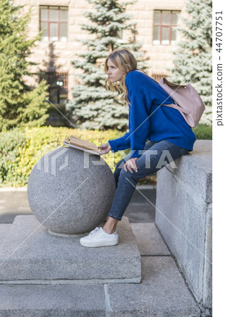 Woman with book studying at the university Woman with book studying at the university 44707751