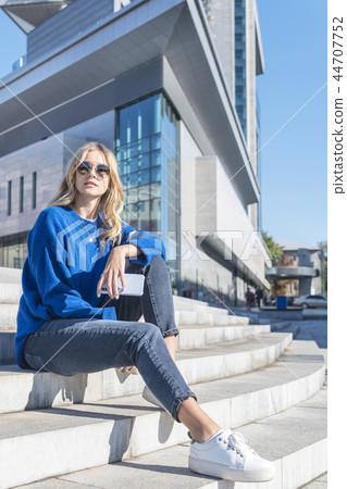 Woman sitting on the stairs Woman sitting on the stairs 44707752