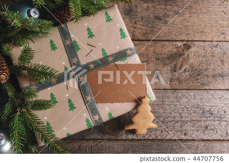 Gift with empty tag and Christmas tree cookie Gift with empty tag and Christmas tree cookie 44707756