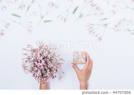 Woman's hands holding small gift box Woman's hands holding small gift box 44707808