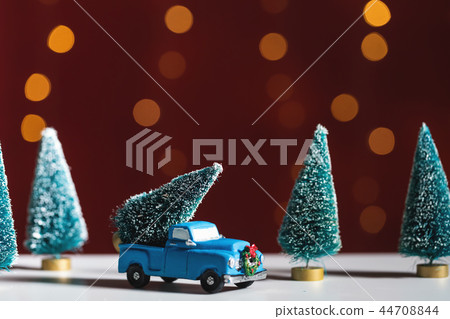 Toy truck carrying a Christmas tree Toy truck carrying a Christmas tree 44708844