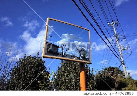 Beautiful clouds and blue sky reflected on mirror, house and utility pole, telegraph pole and electric wire. Mirror and signs 44708996