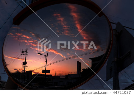 Reflected mirror reflects the power cord, pole and city evening glow 44711087