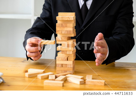 Businessmen picking domino to fill the missing. 44711633