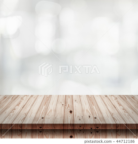 wooden table with blur shopping mall background. 44712186