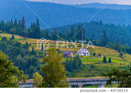 A large rural house with a farmhouse standing on a A large rural house with a farmhouse standing on a 44716514