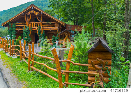 A wooden cafe is fenced with a tin in a forest in A wooden cafe is fenced with a tin in a forest in 44716529