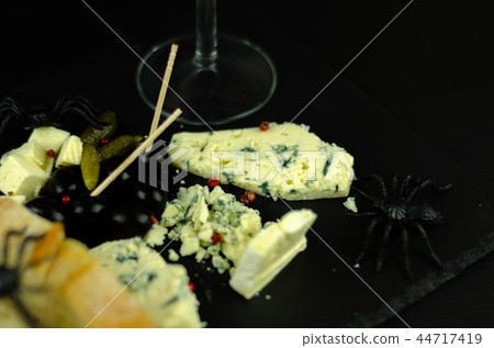 A set of cheeses served in a special form 44717419