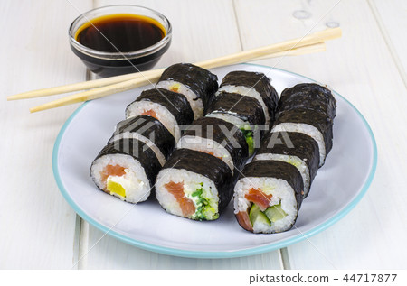 Rolls with salmon, plate on wooden table Rolls with salmon, plate on wooden table 44717877