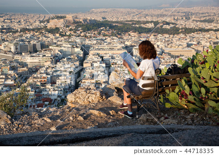 woman with a map sitting on Lycabettus Hill 44718335