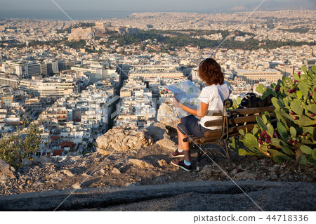 woman with a map sitting on Lycabettus Hill woman with a map sitting on Lycabettus Hill 44718336