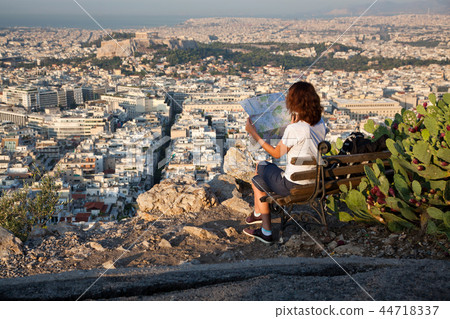 woman with a map sitting on Lycabettus Hill 44718337