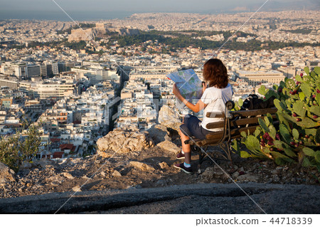 woman with a map sitting on Lycabettus Hill 44718339