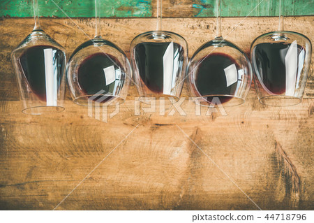 Red wine in glasses over rustic wooden background, copy space Red wine in glasses over rustic wooden background, copy space 44718796