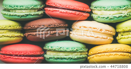 Colorful French macaroons cookies stacked in rows, wide composition 44718808