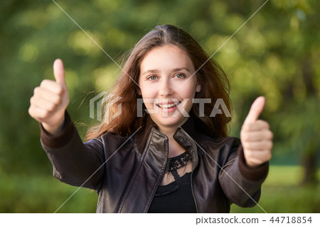Girl gesuritg thumb.housewife optimism gesture Girl gesuritg thumb.housewife optimism gesture 44718854