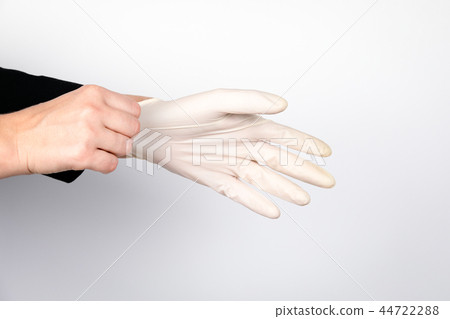 woman doctor wears medical gloves 44722288