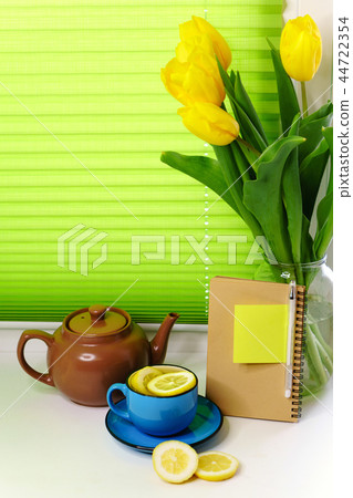 Yellow tulips and tea with lemon Yellow tulips and tea with lemon 44722354