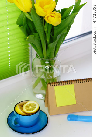 Yellow tulips and tea with lemon Yellow tulips and tea with lemon 44722358