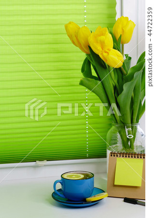 Yellow tulips and tea with lemon Yellow tulips and tea with lemon 44722359