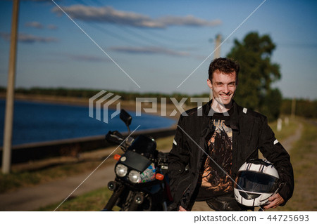 Biker holding his helmet Biker holding his helmet 44725693