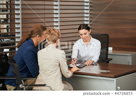 Happy beautiful couple is buying a new car at dealership. Family council Happy beautiful couple is buying a new car at dealership. Family council 44726855