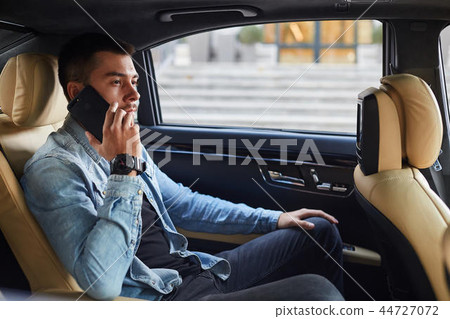 serious pleasant businessman making a phone call 44727072