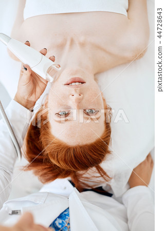 Woman getting rf-lifting in a beauty salon. Modern technologies in cosmetology. 44728643