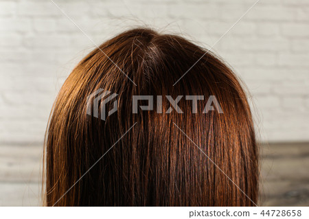 Detail on natural dark brown woman hair  44728658