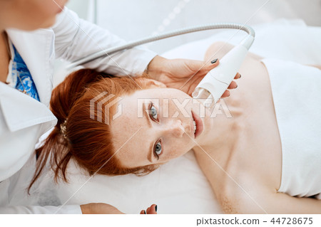 Woman getting rf-lifting in a beauty salon. Modern technologies in cosmetology. 44728675