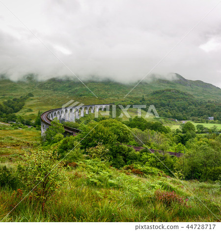 Glenfinnan viaduct in Scotland on overcast day. 44728717