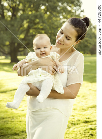 Mother holding baby girl on her hands 44729000
